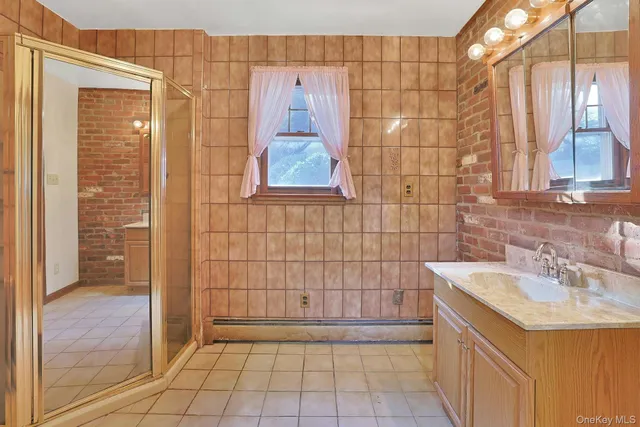 a bathroom with a sink a mirror and shower