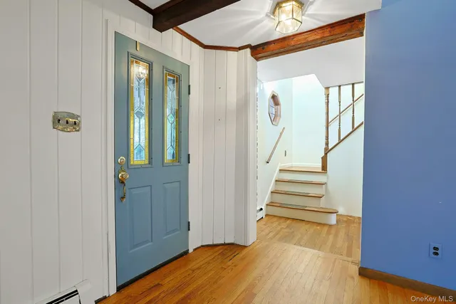 a view of entryway with wooden floor and stairs