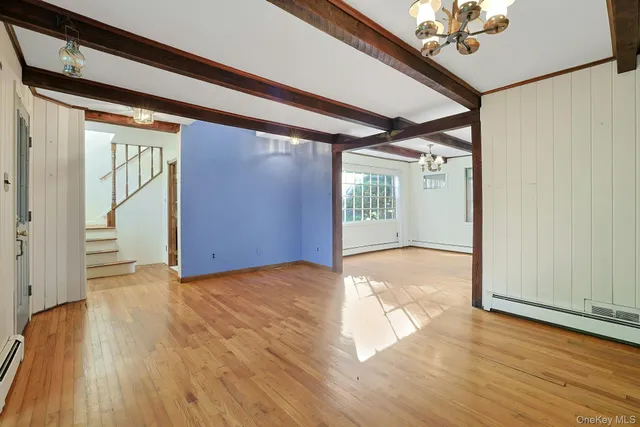 wooden floor in an empty room with a window