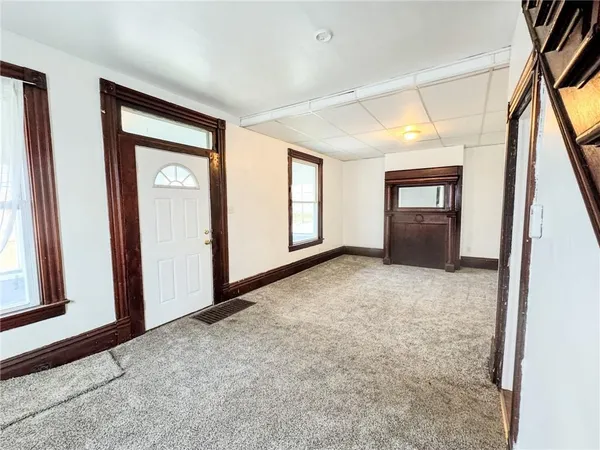 an empty room with windows and closet