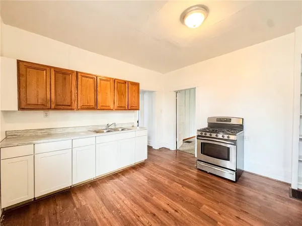 a kitchen with granite countertop a stove and a sink