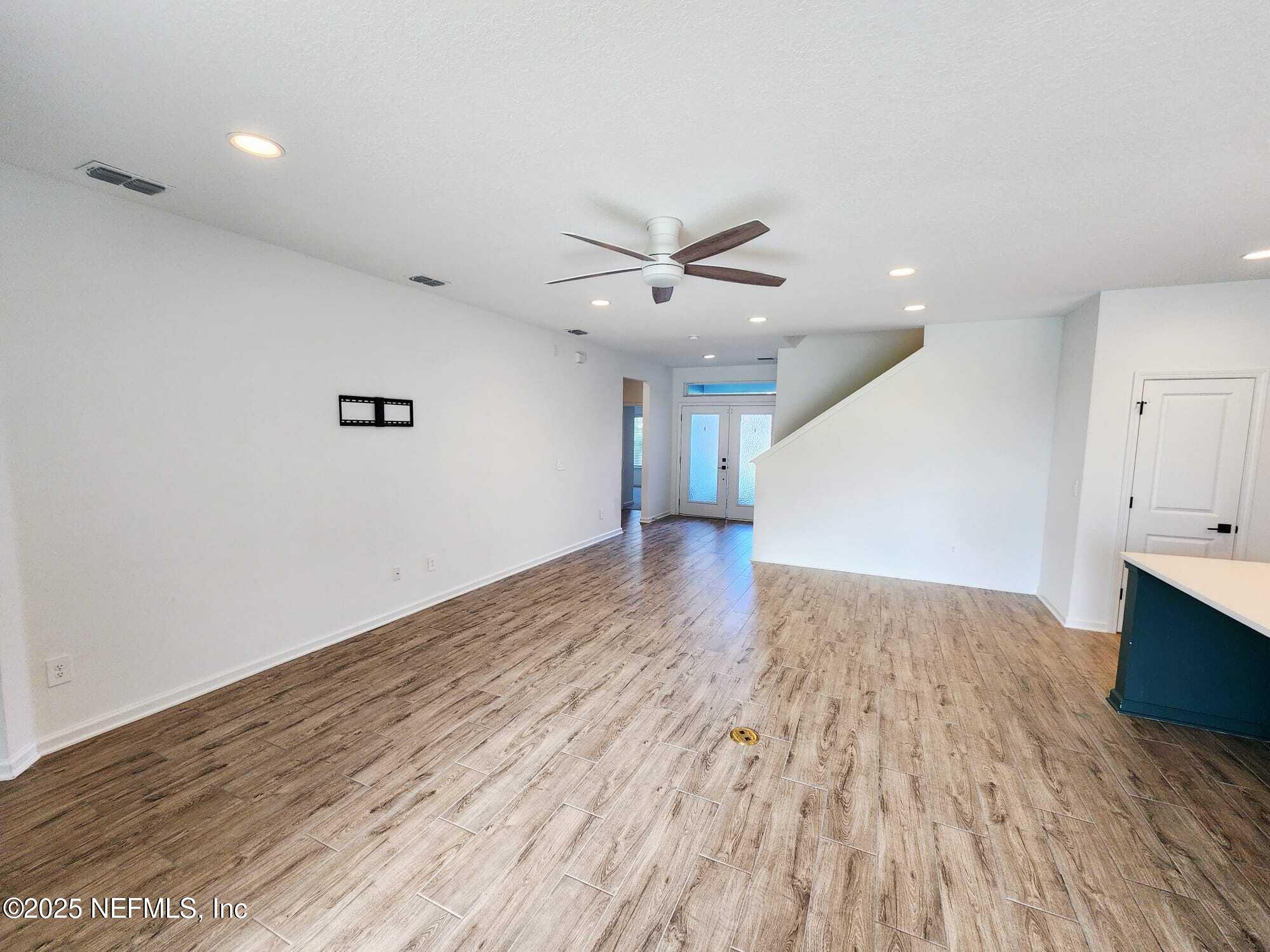 577 Archstone Way St. Augustine, FL 32092 - Photo 13 of 45 an empty room with wooden floor and a ceiling fan
