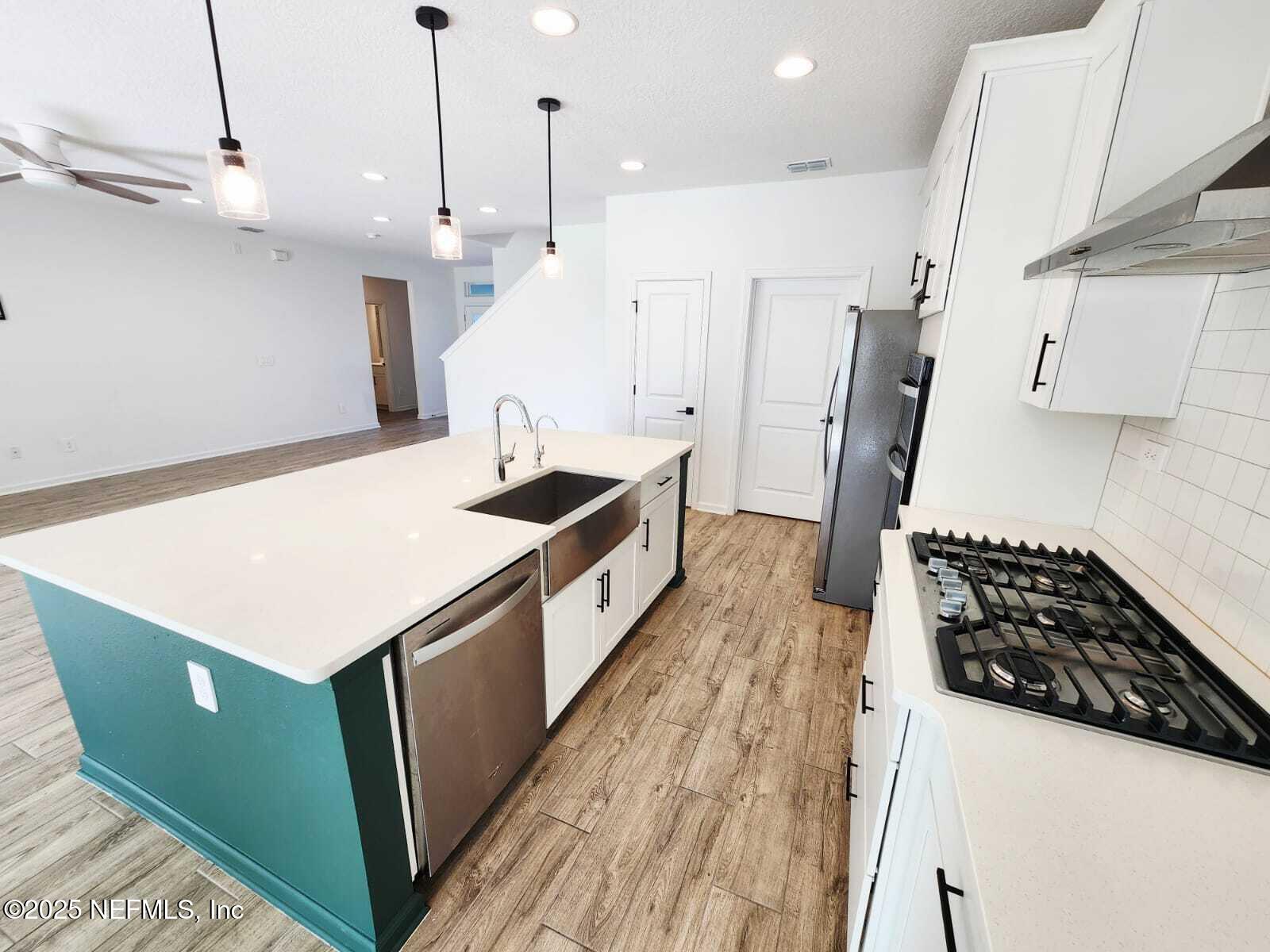 577 Archstone Way St. Augustine, FL 32092 - Photo 14 of 45 a kitchen with a stove and a refrigerator