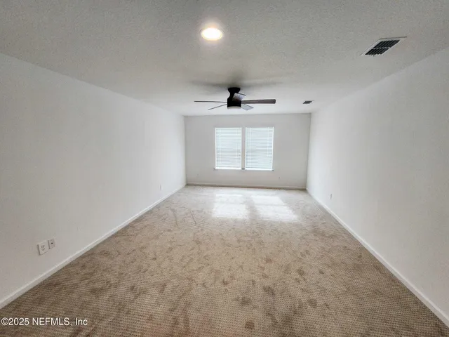 a view of a hallway with wooden floor and closet area