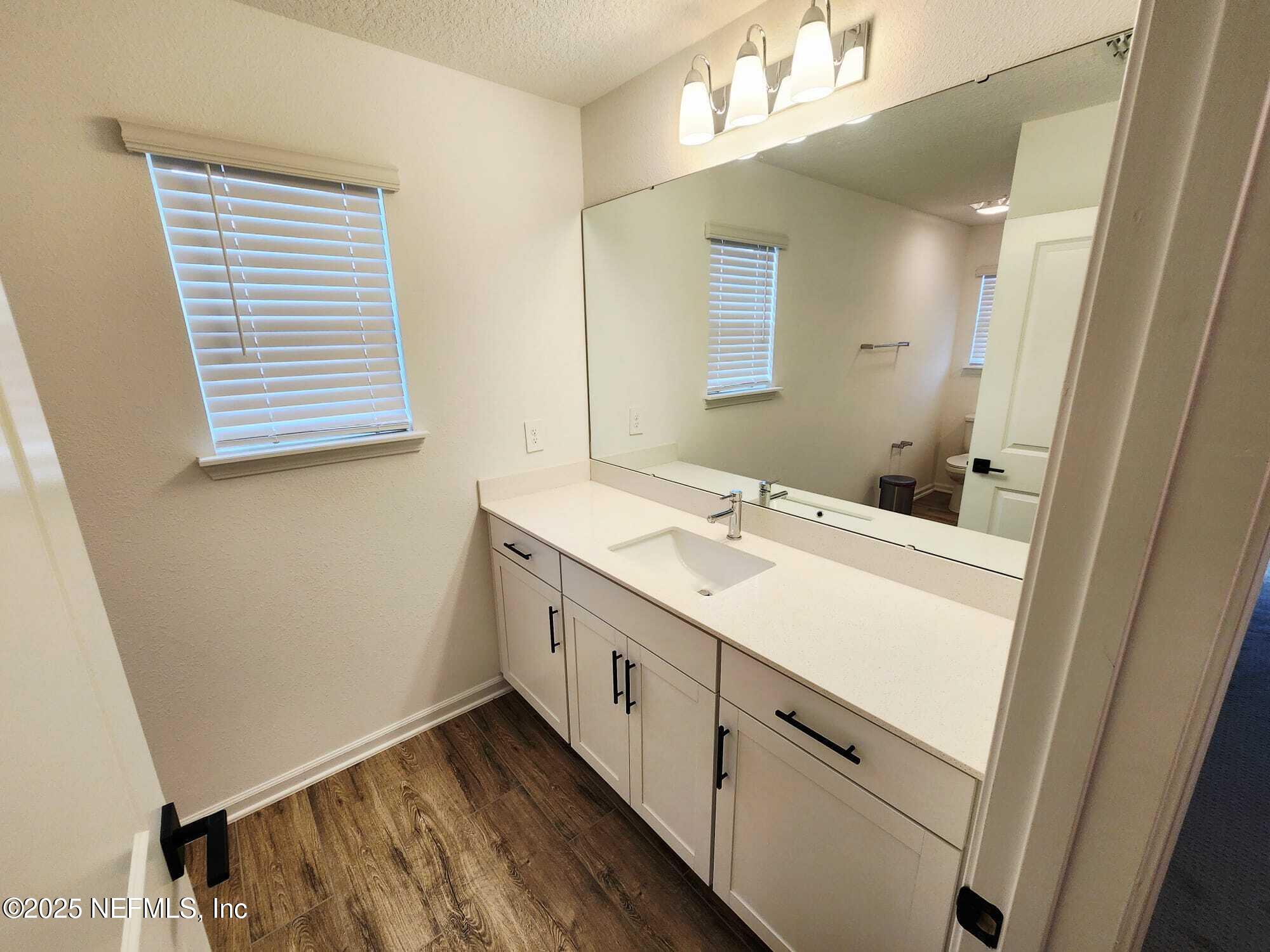 577 Archstone Way St. Augustine, FL 32092 - Photo 23 of 45 a bathroom with a sink a vanity and a mirror