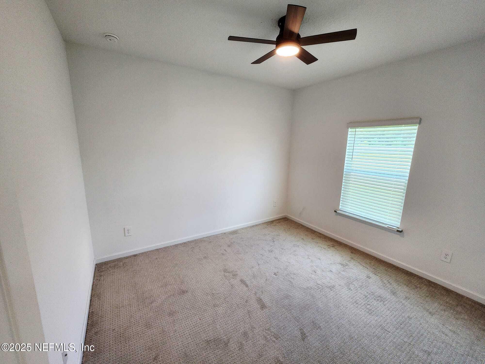 577 Archstone Way St. Augustine, FL 32092 - Photo 30 of 45 an empty room with a ceiling fan and window