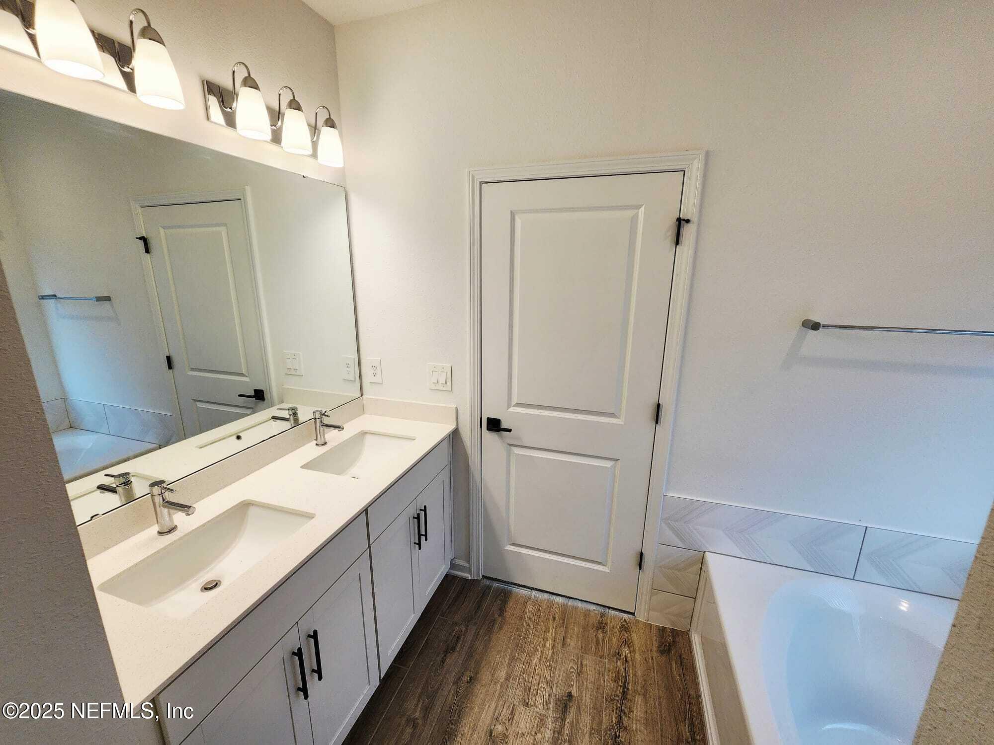 577 Archstone Way St. Augustine, FL 32092 - Photo 38 of 45 a bathroom with a double vanity sink and mirror
