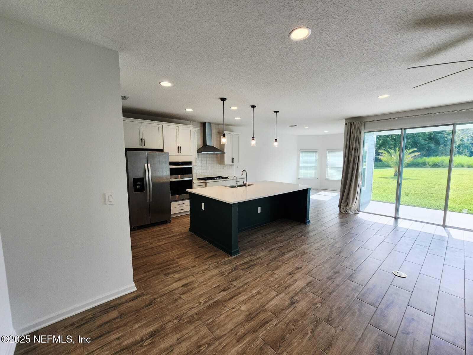 577 Archstone Way St. Augustine, FL 32092 - Photo 9 of 45 a large kitchen with stainless steel appliances granite countertop a large counter top a sink and a refrigerator