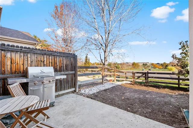 a view of a backyard with wooden fence