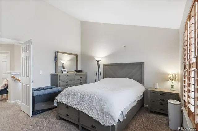 a bedroom with a bed and a mirror