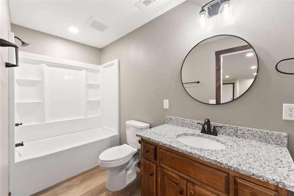 707 South Fern Cove Road Sautee Nacoochee, GA 30571 - Photo 31 of 60 a bathroom with a granite countertop sink toilet and a mirror
