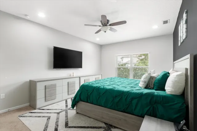 a bedroom with a bed and a flat screen tv