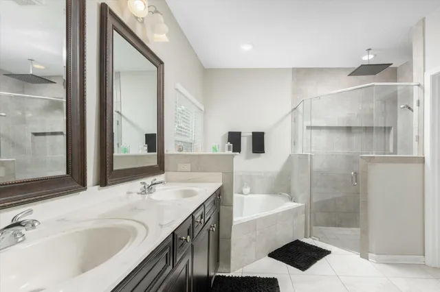 a bathroom with a tub sink and mirror