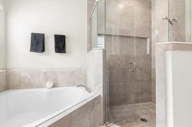 a bathroom with a bathtub and a shower