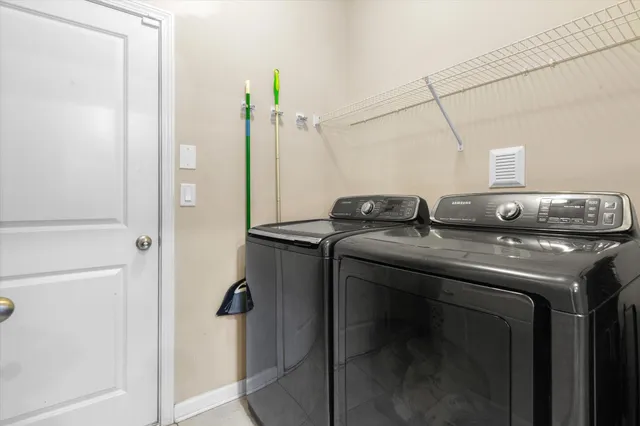a bathroom with a granite countertop sink and washing machine