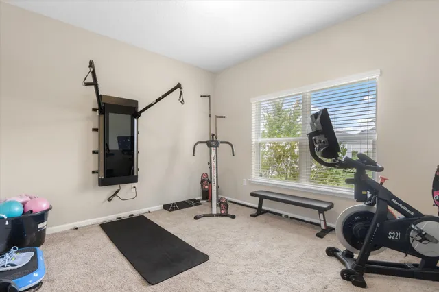 a view of a room with gym equipment and windows