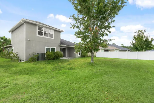 a view of a house with a backyard