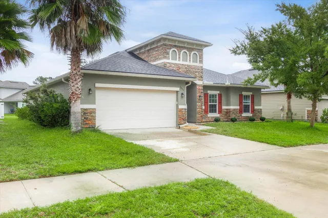 a front view of a house with a yard and garage