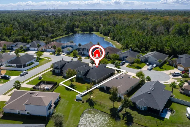 an aerial view of residential house with outdoor space and swimming pool