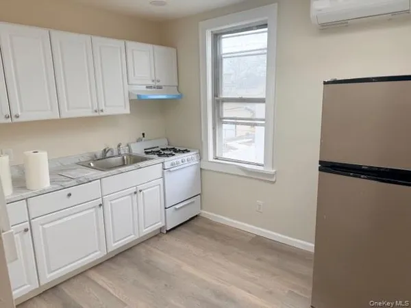 a kitchen with a sink window and cabinets