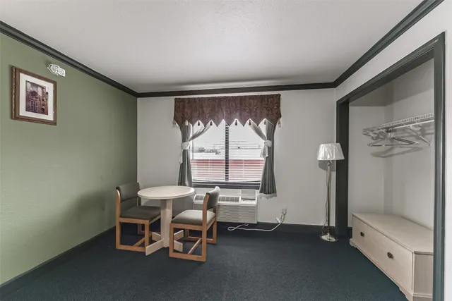 a dining room with furniture and window