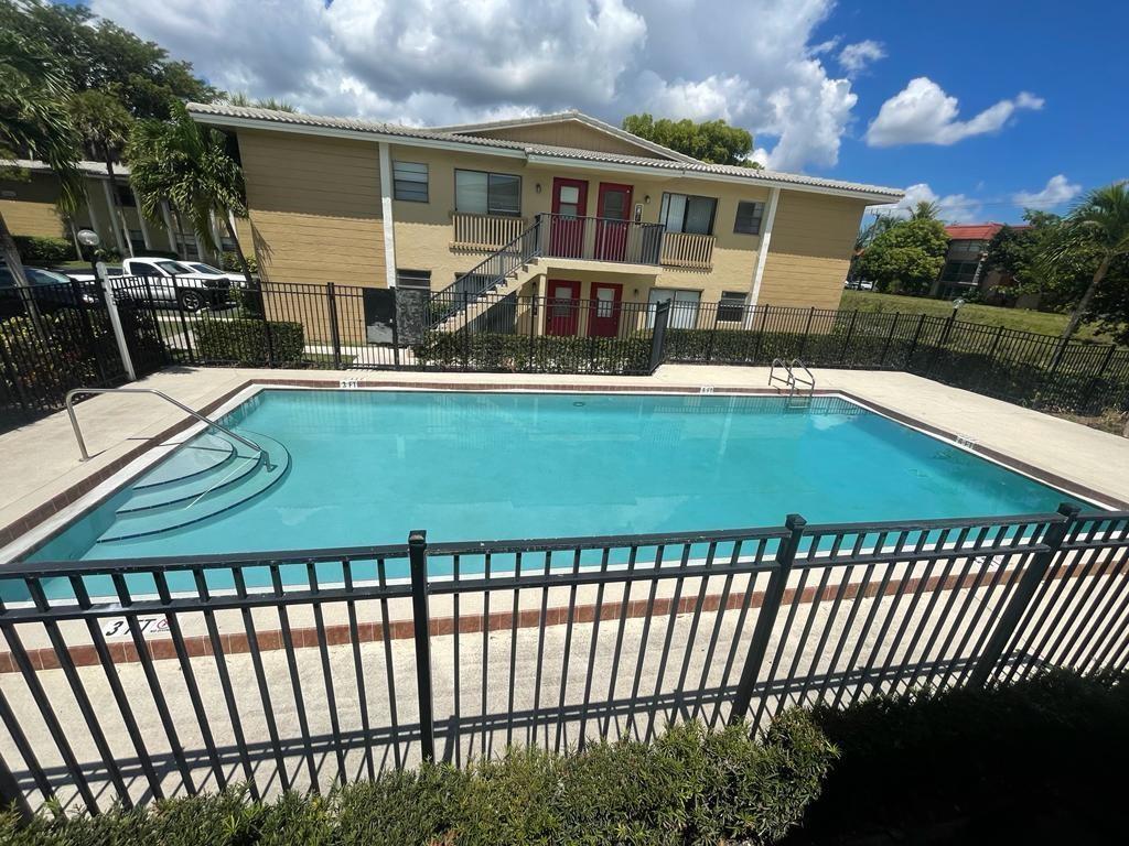 2621 Riverside Drive, Unit 6 Coral Springs, FL 33065 - Photo 18 of 20 a view of a house with a swimming pool