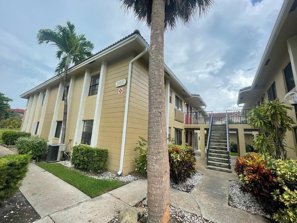 2621 Riverside Drive, Unit 6 Coral Springs, FL 33065 - Photo 19 of 20 a front view of a house with a garden