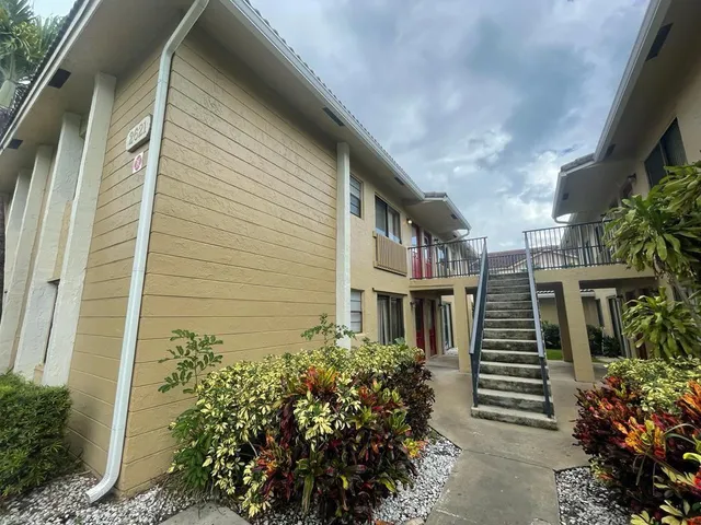 a front view of a multi story building with a yard