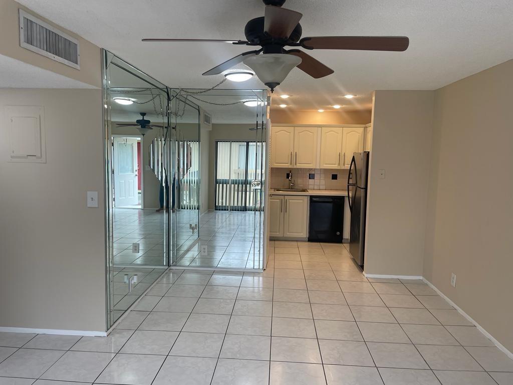 2621 Riverside Drive, Unit 6 Coral Springs, FL 33065 - Photo 2 of 20 a bathroom with a glass door shower a sink and a mirror