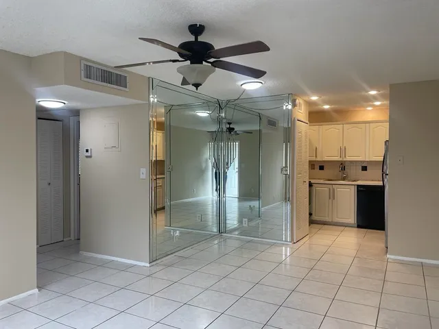 a view of a kitchen with a refrigerator and a sink