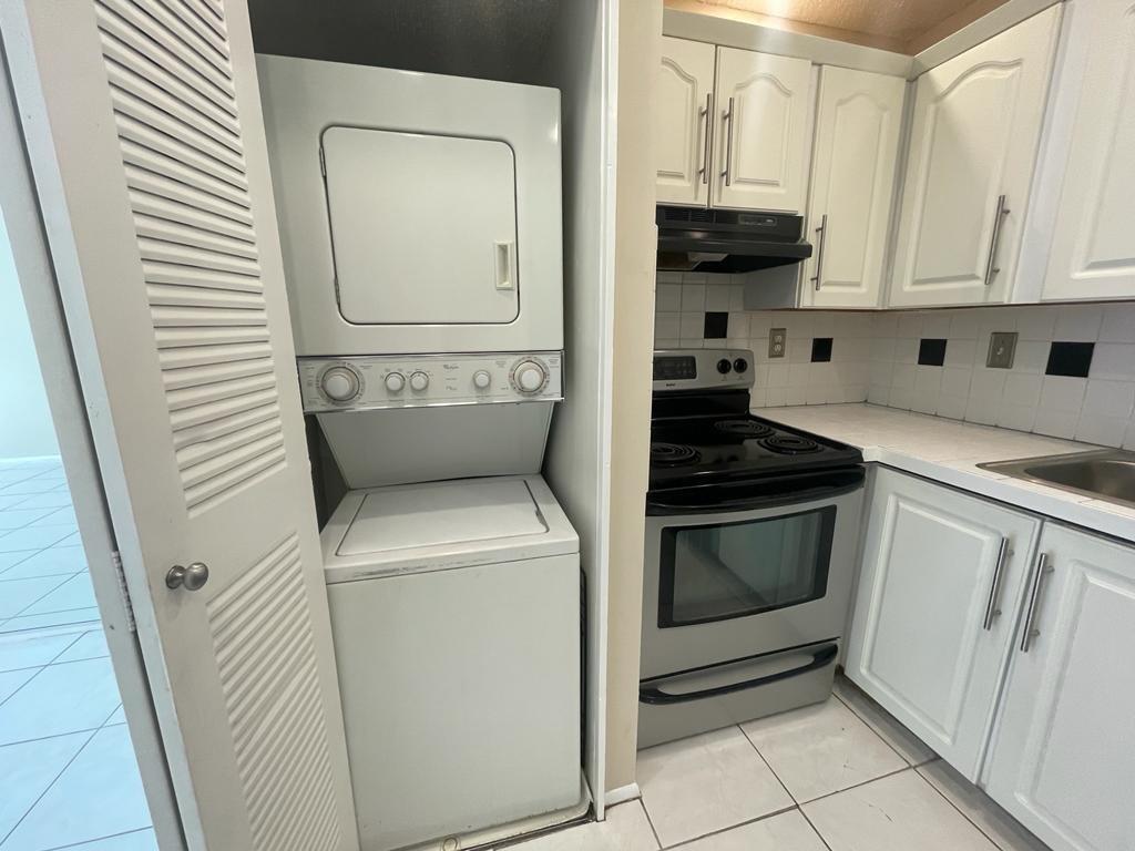 2621 Riverside Drive, Unit 6 Coral Springs, FL 33065 - Photo 5 of 20 a kitchen with a stove and a microwave