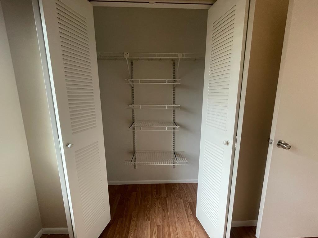2621 Riverside Drive, Unit 6 Coral Springs, FL 33065 - Photo 9 of 20 a view of walk in closet with wooden floor