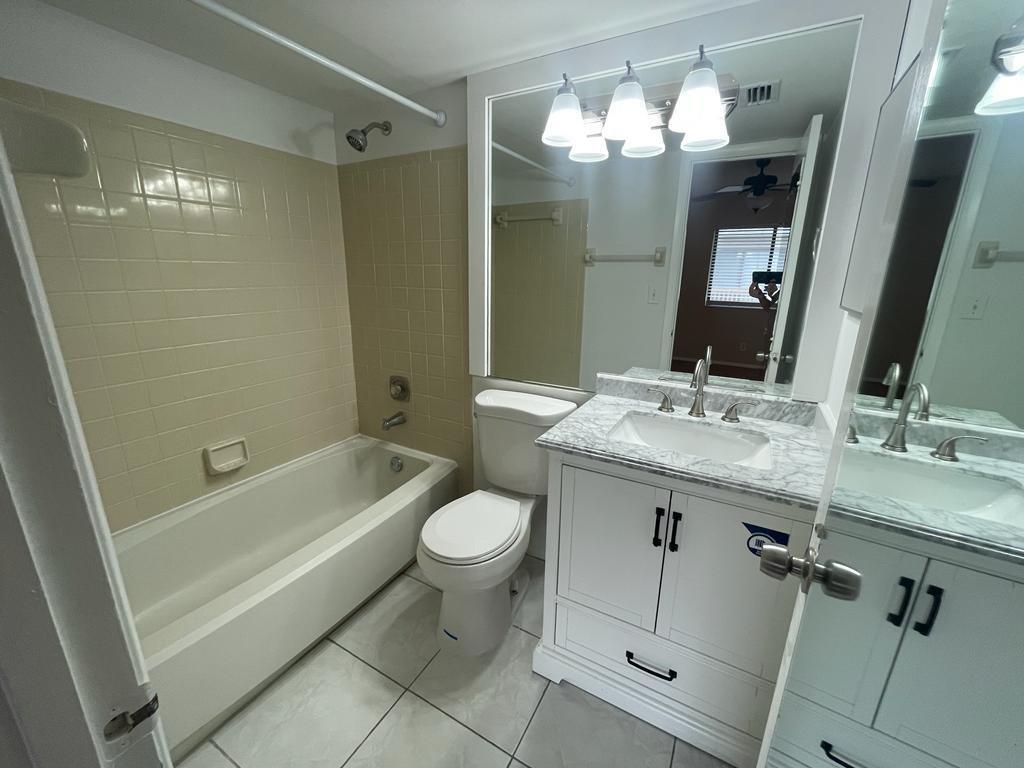 2621 Riverside Drive, Unit 6 Coral Springs, FL 33065 - Photo 10 of 20 a bathroom with a sink a toilet and shower