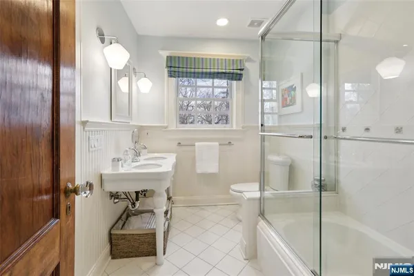 a bathroom with a shower sink and mirror