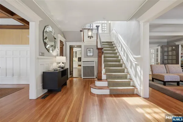 a view of entryway and hall with wooden floor