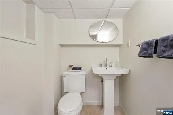 a bathroom with a sink a mirror and toilet