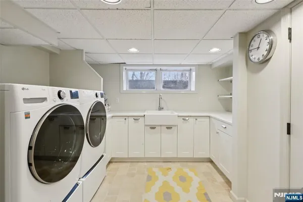a view of a storage & utility room with a washer dryer