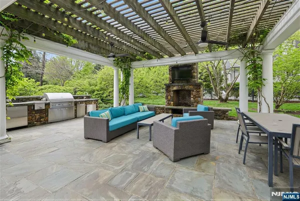 a living room with patio furniture and a grill