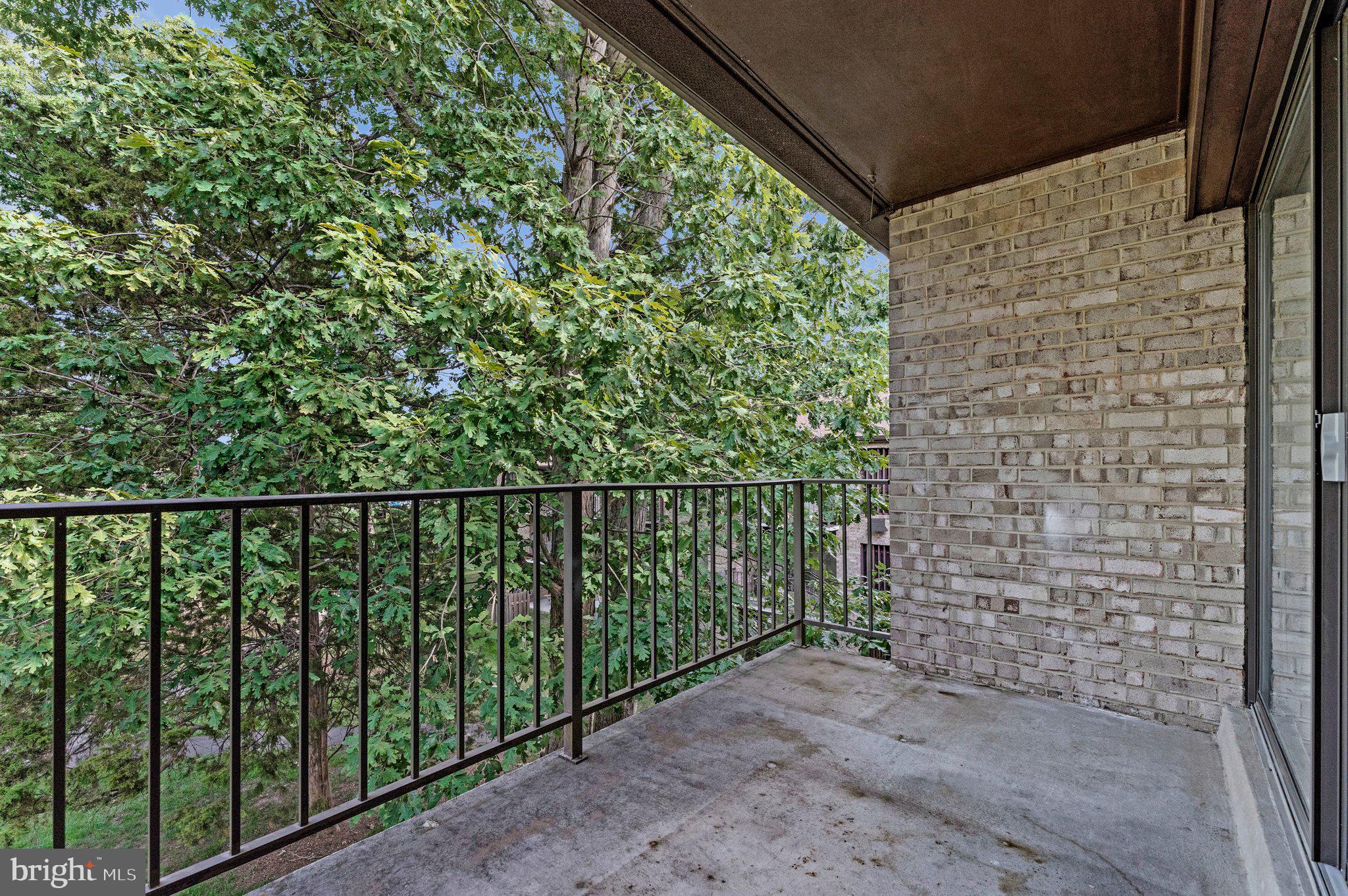 2012 Colts Neck Road, Unit 21A Reston, VA 20191 - Photo 29 of 44 Serene balcony with lush greenery view.