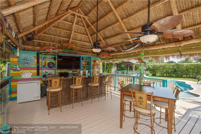 Tiki Hut & Bar with a deck leading to pool area