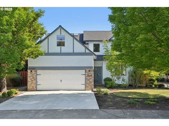 a view of a house with a yard and garage
