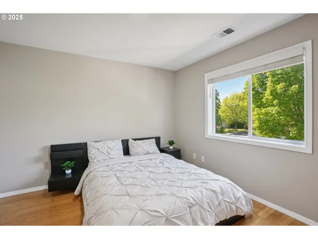 a bed sitting in a bedroom next to a window