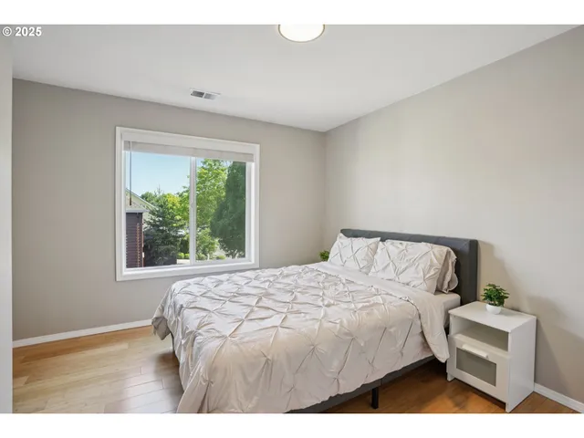 a bedroom with a large bed and a window