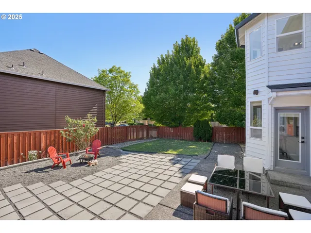 a view of a park with furniture and a small garden