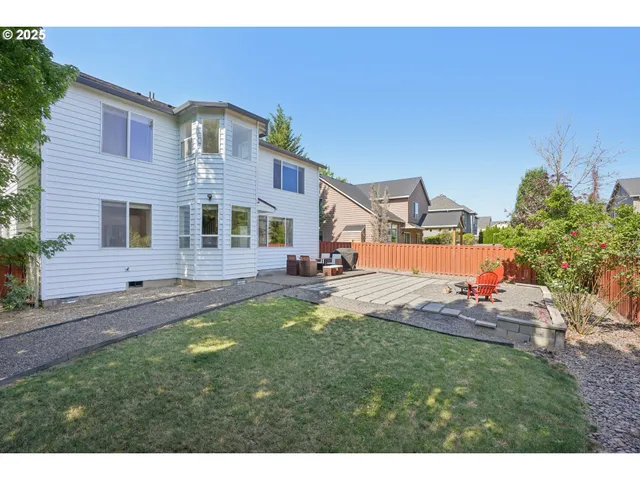 a view of a swimming pool with a yard and sitting area