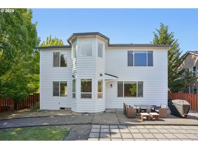 a view of a roof deck with couches and wooden floor