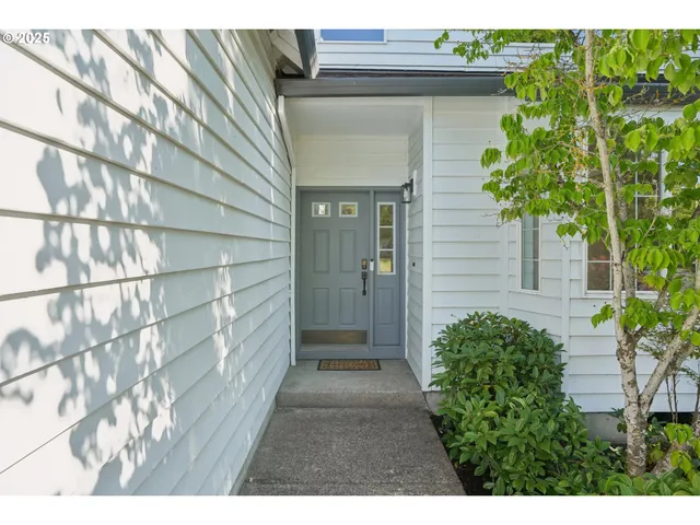 a living room with furniture and a dining table