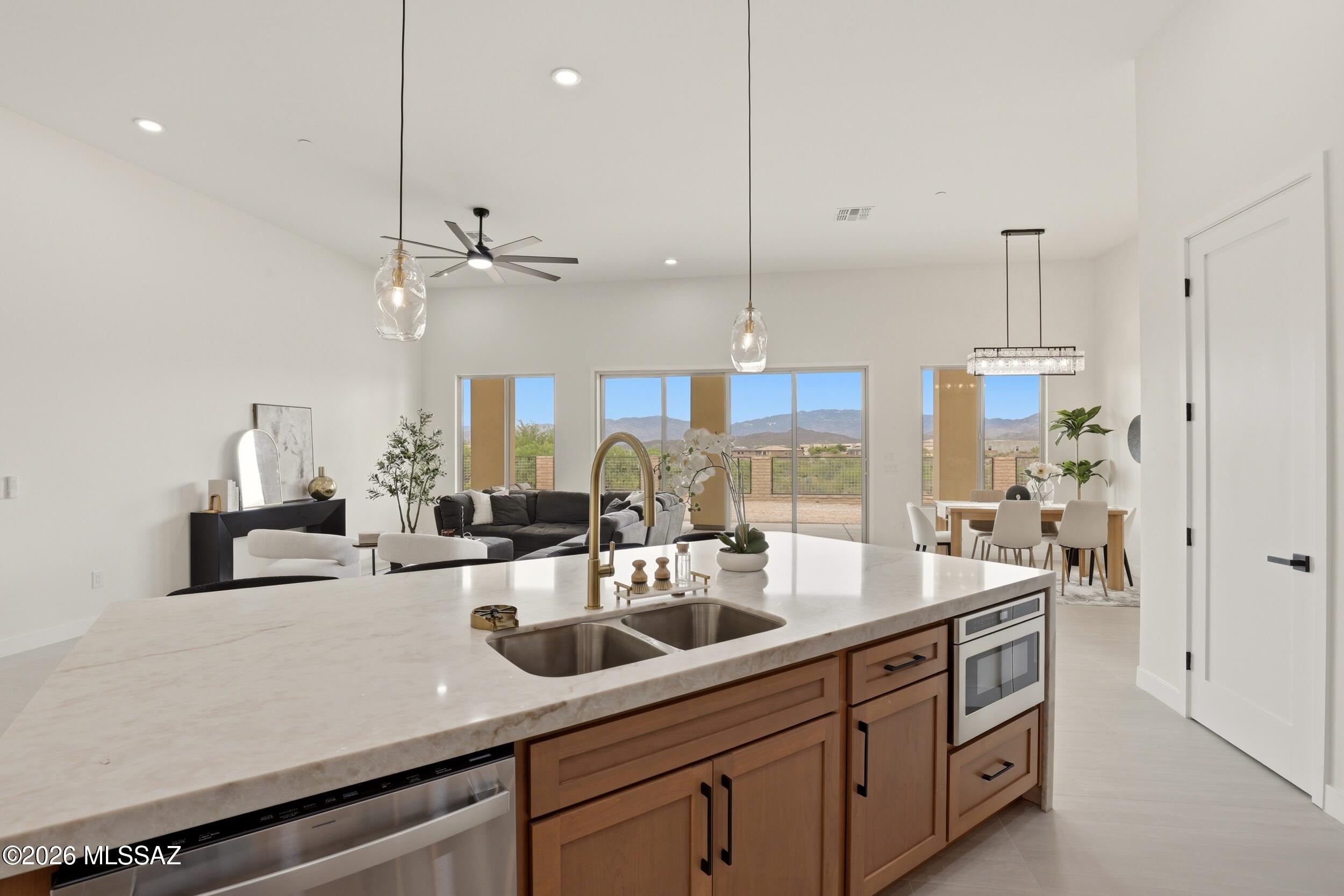 14527 East Sands Ranch Road Vail, AZ 85641 - Photo 11 of 48 a kitchen with kitchen island a sink stainless steel appliances and living room view