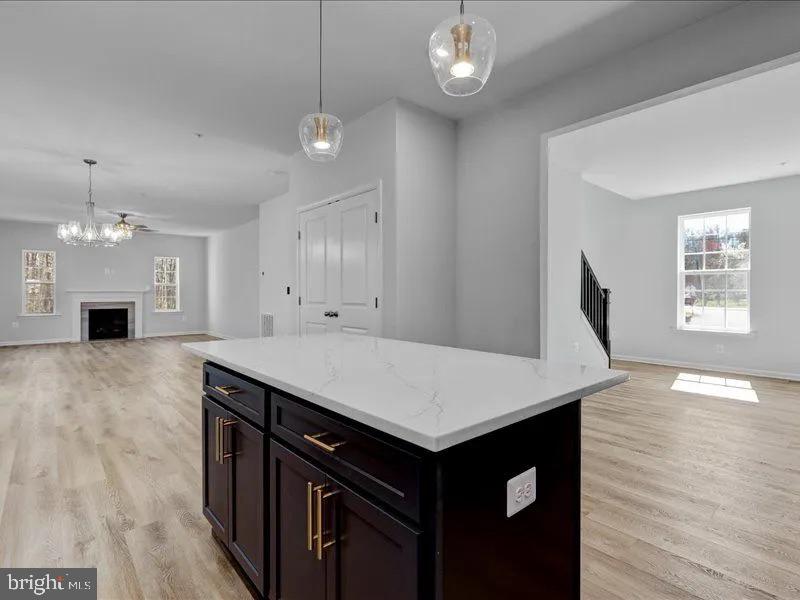 6517 Suitland Road Suitland, MD 20746 - Photo 5 of 10 an empty room with wooden floor and window
