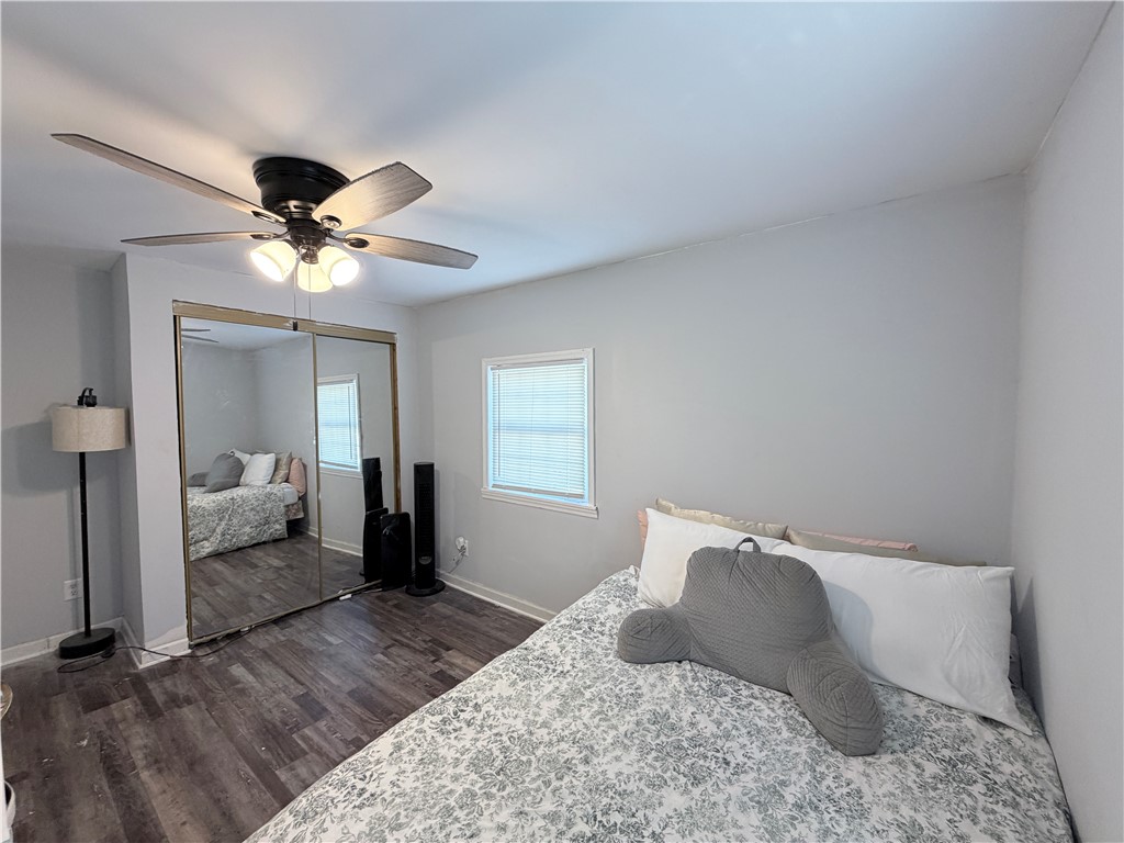 6800 Farmington Road Miamisburg, OH 45342 - Photo 21 of 32 This cozy bedroom features a ceiling fan, mirrored closet doors, and hardwood flooring.